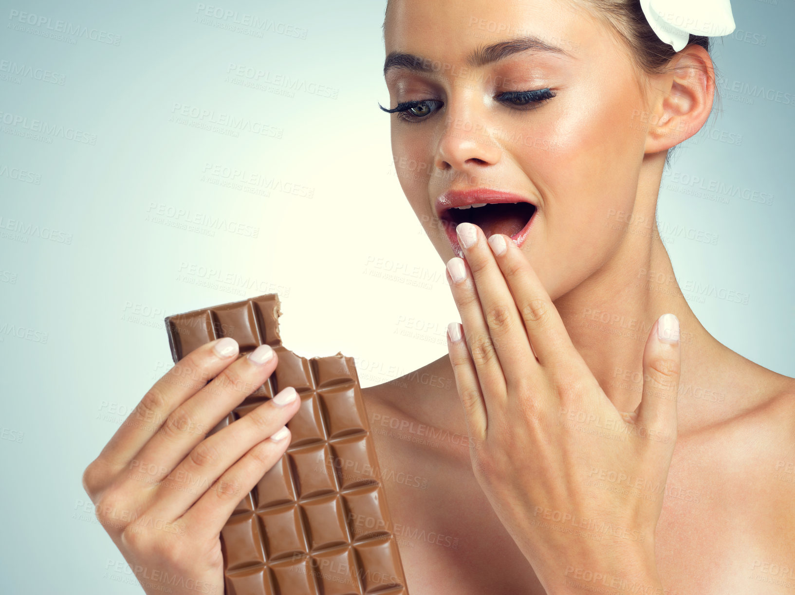 Buy stock photo Studio, shock and woman with chocolate for eating, snack and dessert for female person. Happiness, girl and sweets for mood enhance, candy and cognitive benefits for memory by gray background