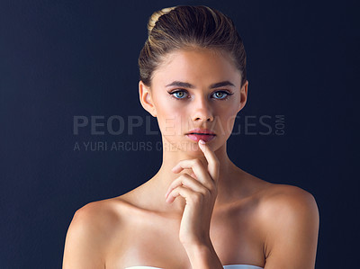 Buy stock photo Studio shot of an attractive young woman posing and touches her lips with her index finger