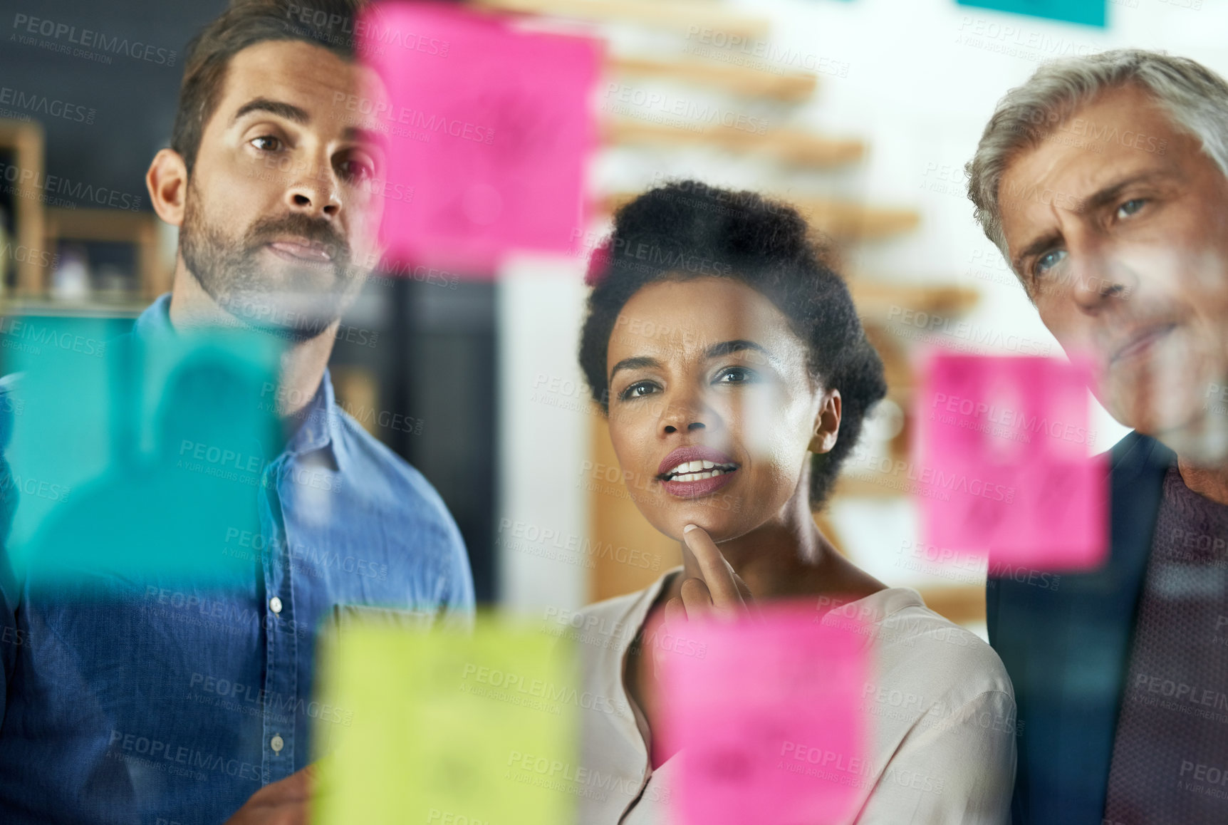 Buy stock photo Shot of a group of colleagues having a brainstorming session in a modern office