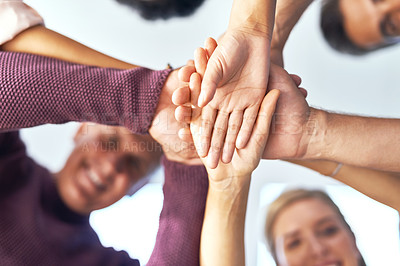 Buy stock photo Cropped shot of a team of colleagues joining their hands in solidarity