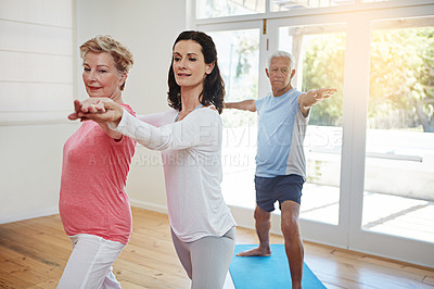 Buy stock photo Cropped shot of a female yoga instructor working with a senior couple
