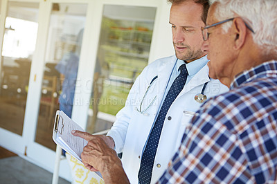 Buy stock photo Cropped shot of a male doctor talking to a senior patient in the retirement home