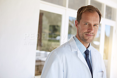 Buy stock photo Cropped portrait of a mature male doctor standing in a retirement home