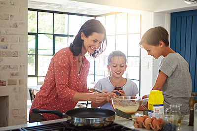Buy stock photo Cropped shot of a mother baking with her children in the kitchen
