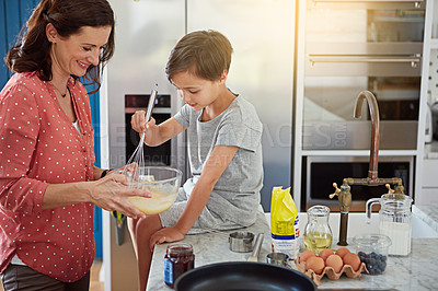 Buy stock photo Cropped shot of a mother baking with her son in the kitchen