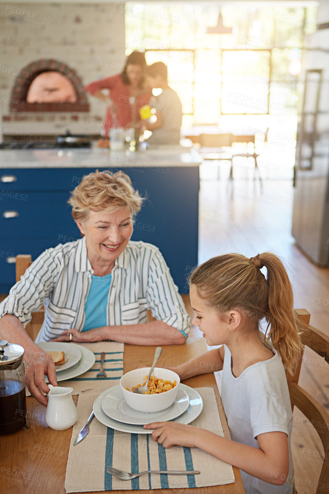 Buy stock photo Cropped shot of a little girl having breakfast with her grandmother