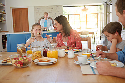 Buy stock photo Food, breakfast and smile with a family at a dining room table in their home together for health or nutrition. Brother, sister and parents eating a meal in their apartment for love or morning bonding