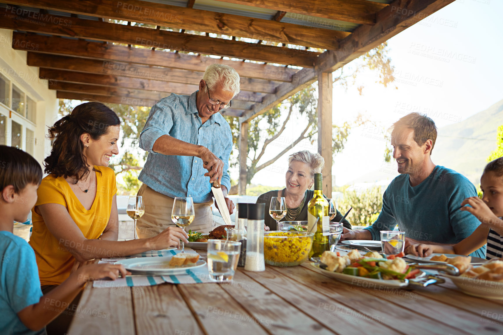 Buy stock photo Table, food and family outdoors for lunch, supper and eating meal together for Christmas. Celebration, parents and children with dish for bonding, relax and talking for nutrition, health and wellness