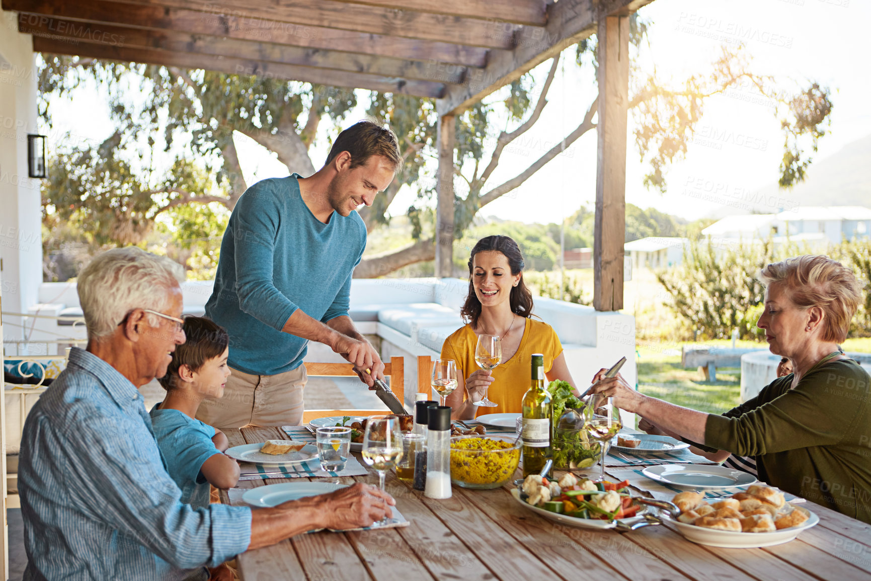 Buy stock photo Table, food and family outdoors for lunch, supper and eating meal in backyard together. Celebration, parents and children with dish for bonding, relax and talking for nutrition, health and wellness