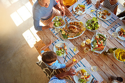 Buy stock photo Cropped shot of a family enjoying a meal together at home