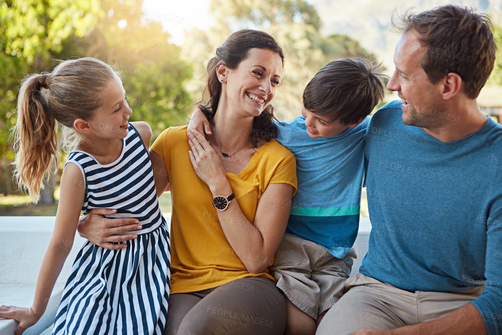 Buy stock photo Shot of a family of four spending time together in their backyard