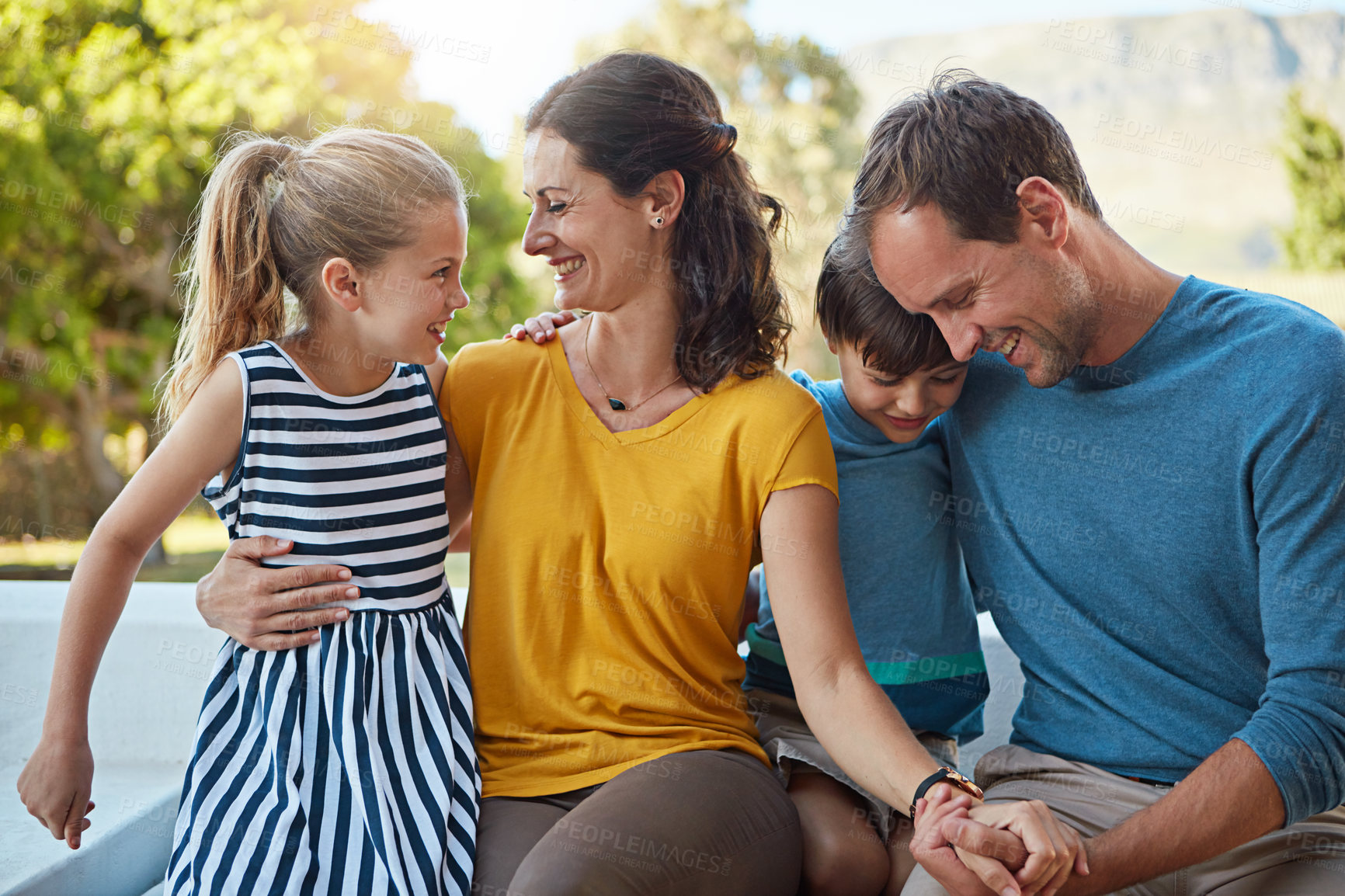 Buy stock photo Shot of a family of four spending time together in their backyard