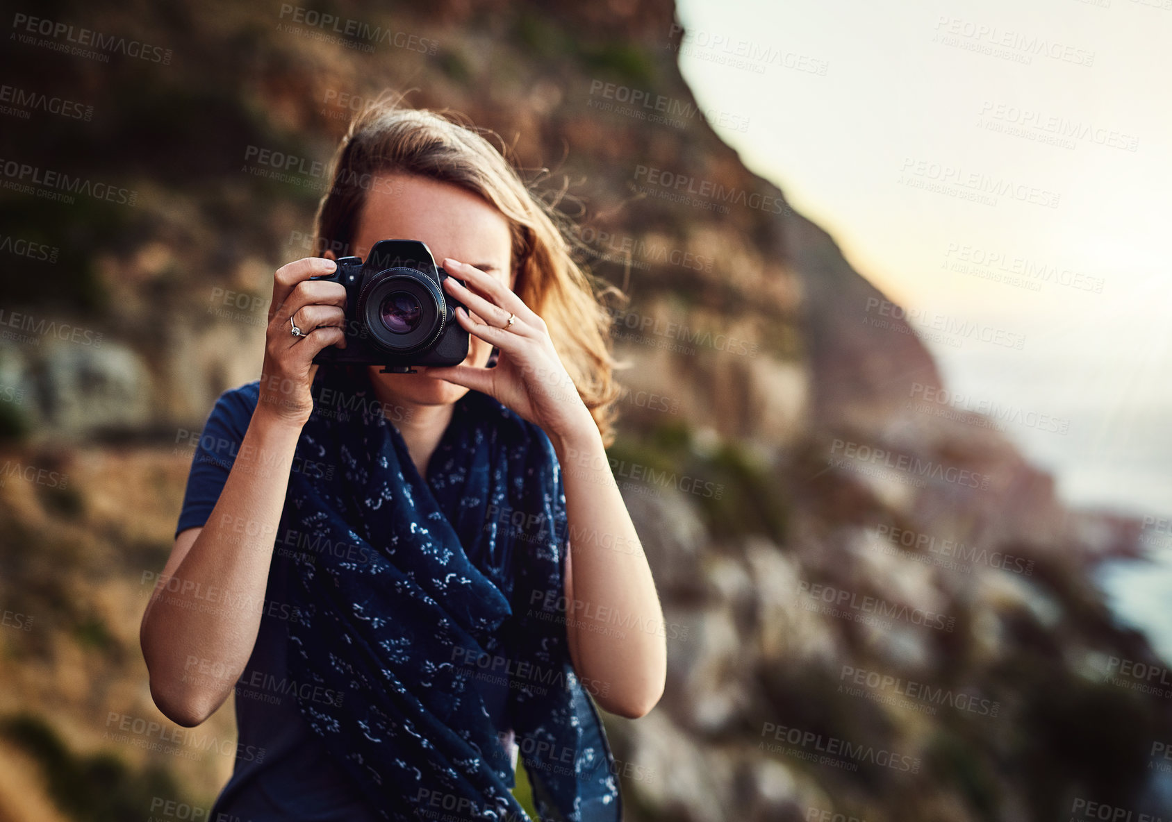 Buy stock photo Travel, photography and woman with camera at a beach for perspective, shooting or scenic recording in nature. Freedom, lens and girl at the ocean for digital, photoshoot or sunset, vacation or trip