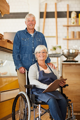Buy stock photo Portrait of two happy senior business owners posing together inside their coffee shop