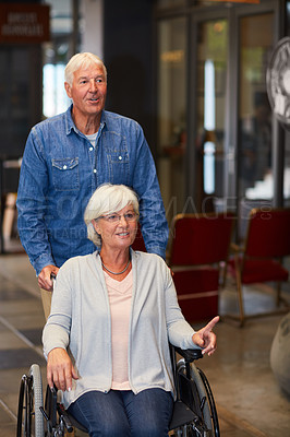 Buy stock photo Shot of a happy senior couple bonding at the mall on the weekend