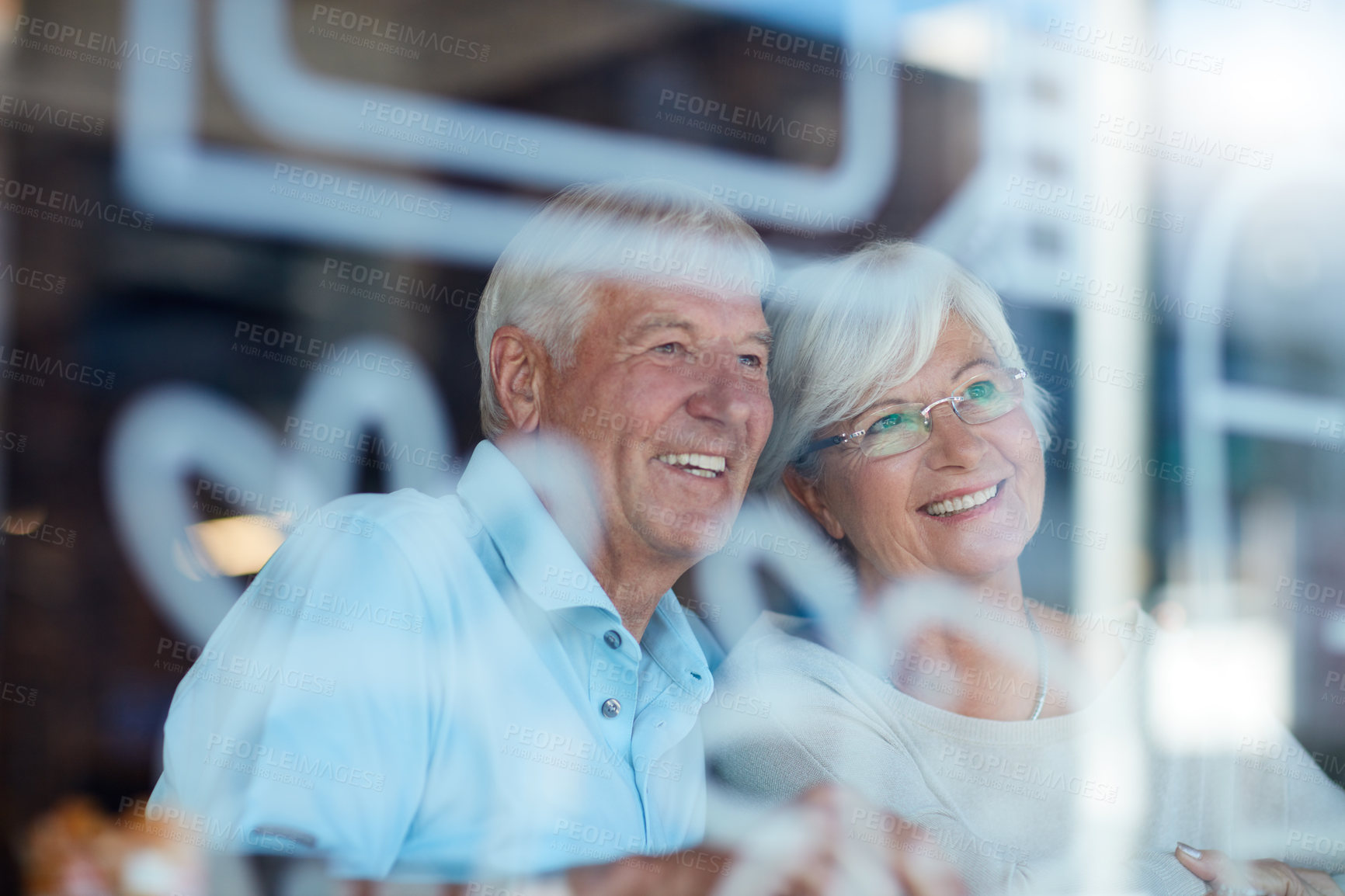 Buy stock photo Cropped shot of an affectionate senior couple in their local coffee shop