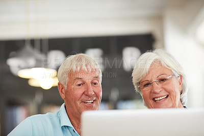 Buy stock photo Shot of a senior couple using a laptop together