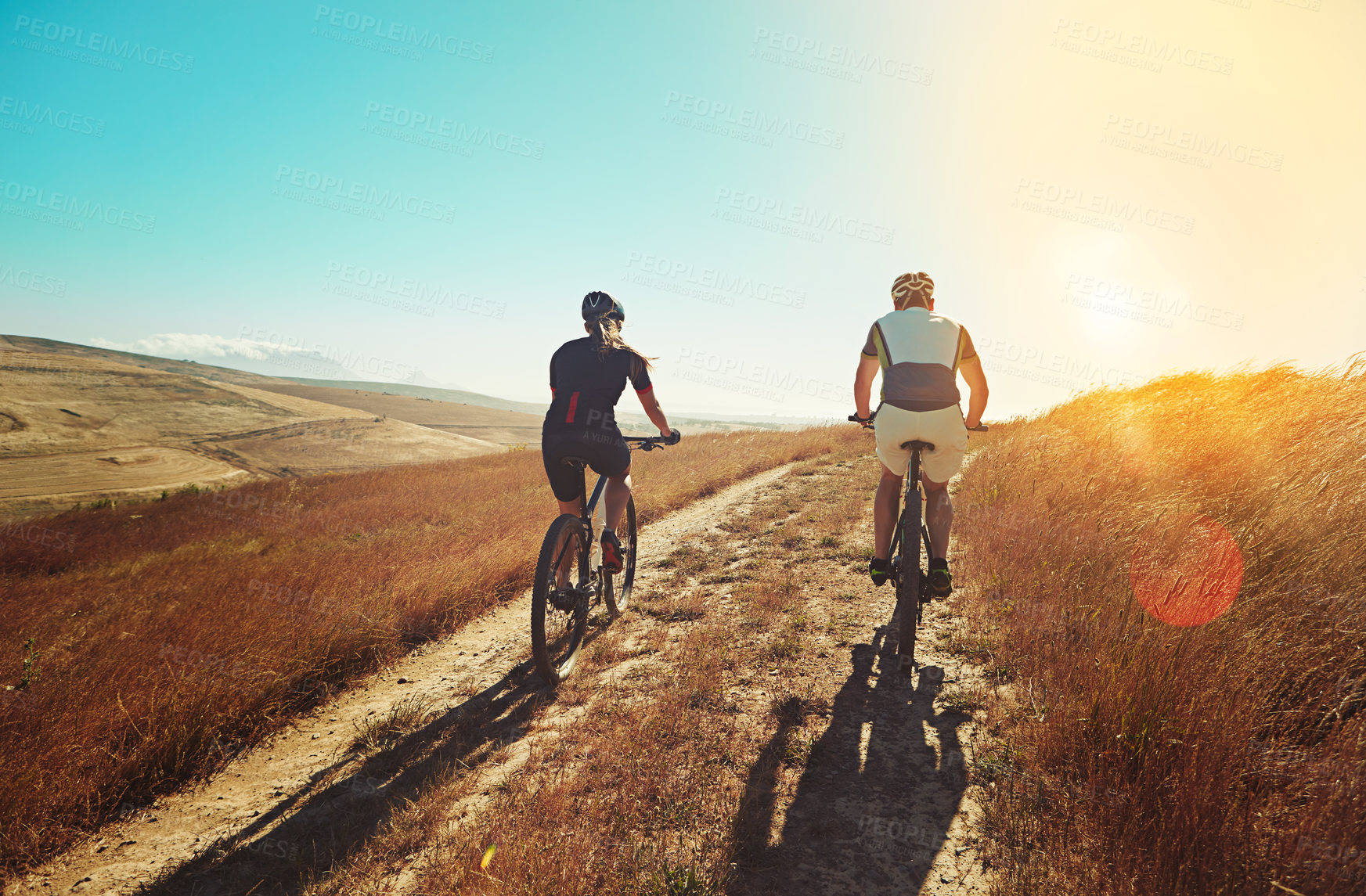 Buy stock photo Shot of two cyclists out cycling in the countryside