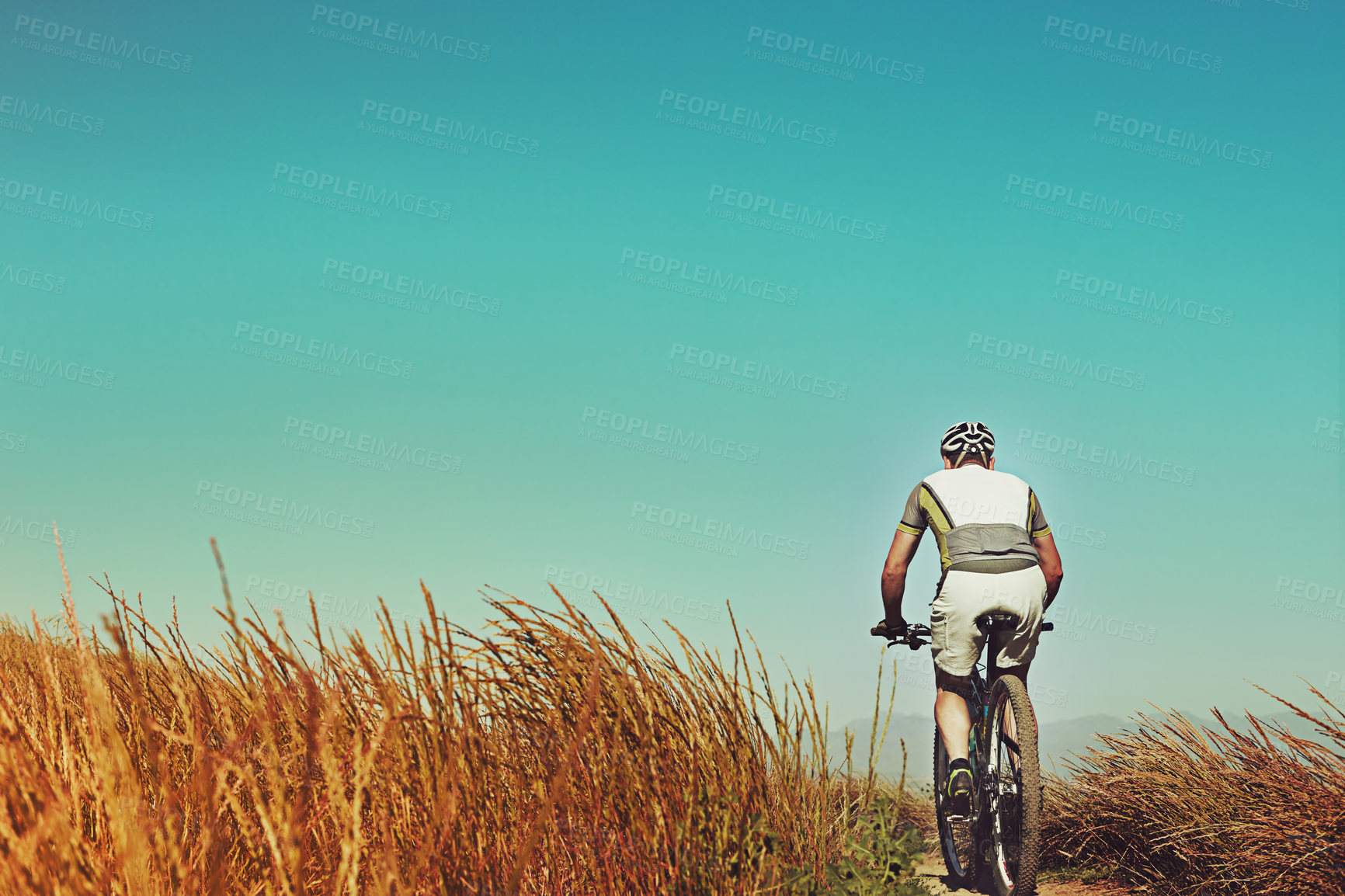 Buy stock photo Countryside, mountain bike and man with training, back and travel with journey, practice and wellness. Cyclist, transport or person with cardio, low angle or helmet for safety, hobby or challenge