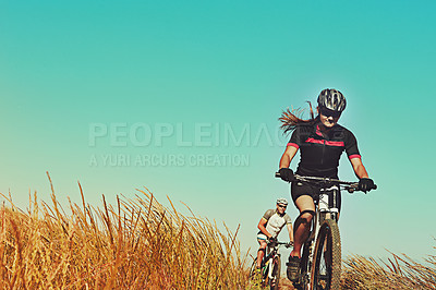 Buy stock photo Cropped shot of  an adventurous woman out cycling in the countryside