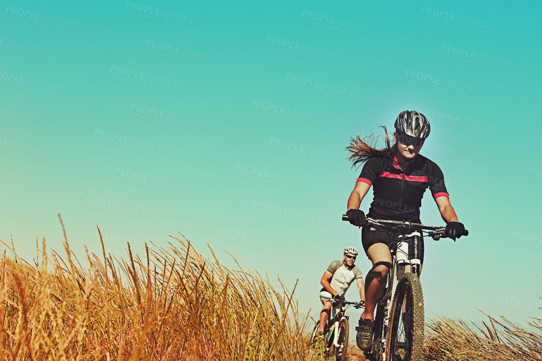 Buy stock photo Cropped shot of  an adventurous woman out cycling in the countryside