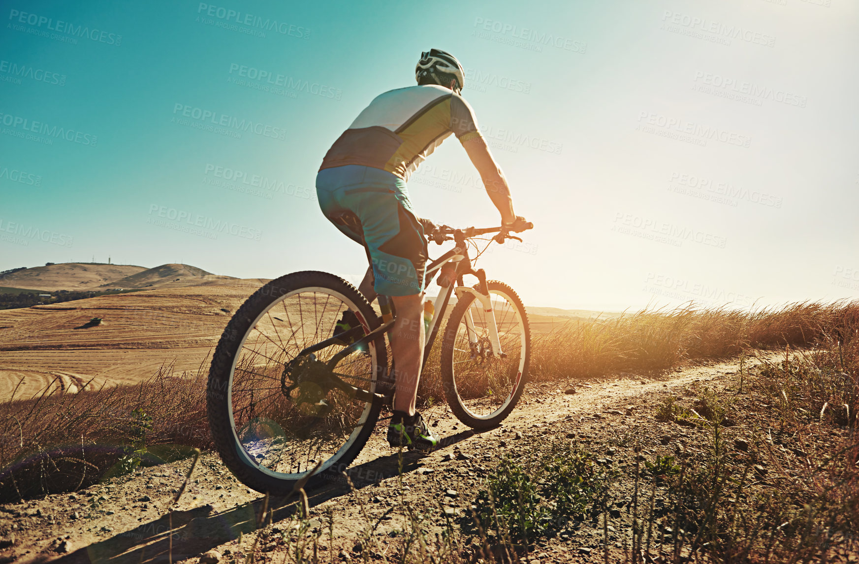 Buy stock photo Cropped shot of a man out cycling in the countryside