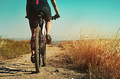 Buy stock photo Cropped shot of  an adventurous woman out cycling in the countryside