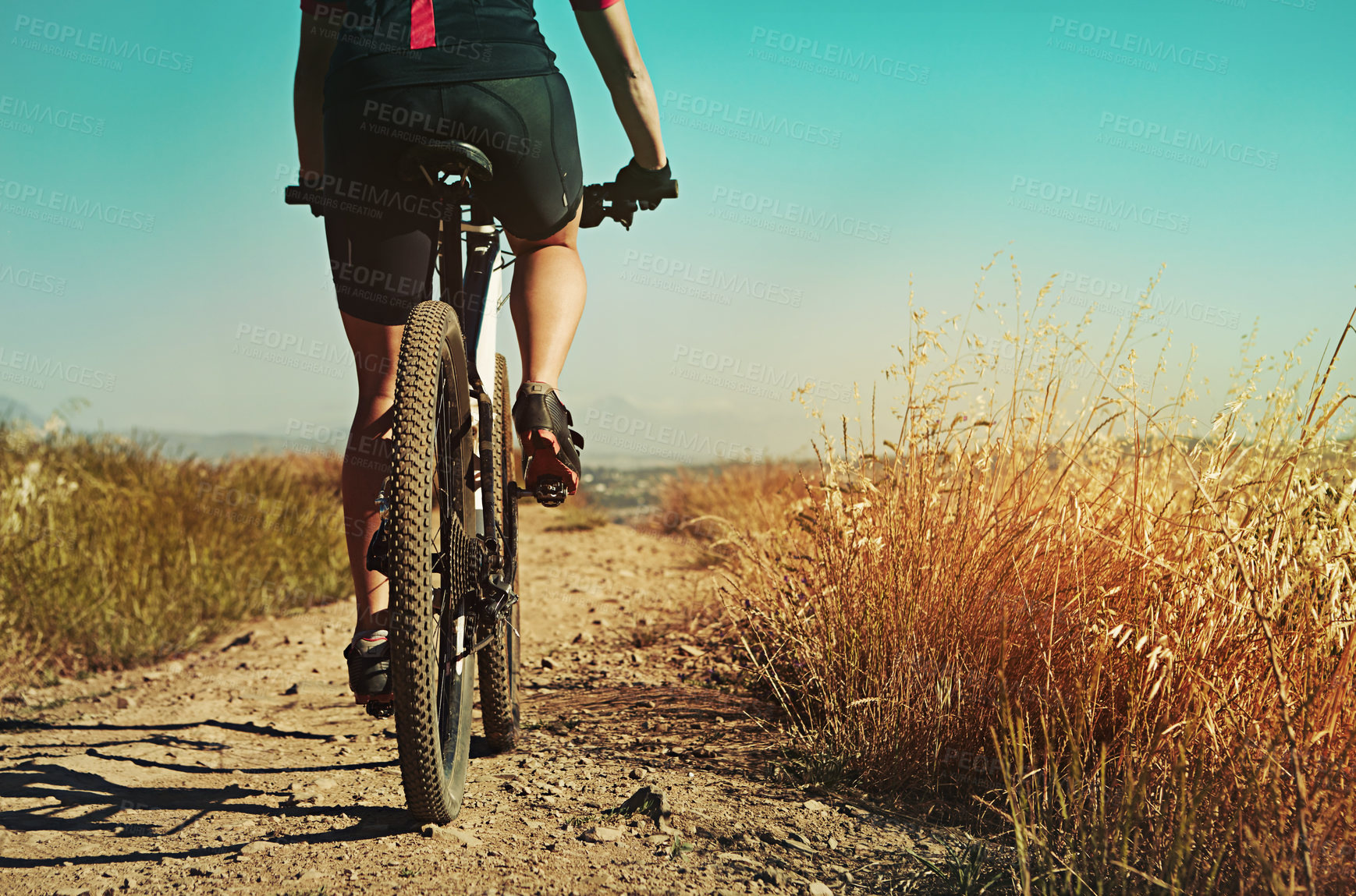 Buy stock photo Cropped shot of  an adventurous woman out cycling in the countryside