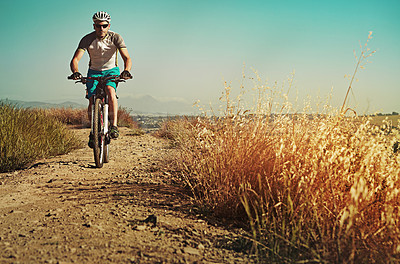 Buy stock photo Cropped shot of a man out cycling in the countryside