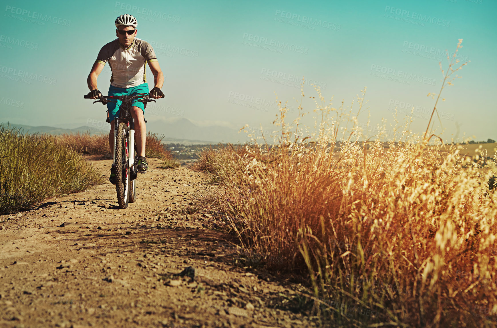 Buy stock photo Cropped shot of a man out cycling in the countryside