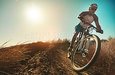 Buy stock photo Cropped shot of a man out cycling in the countryside