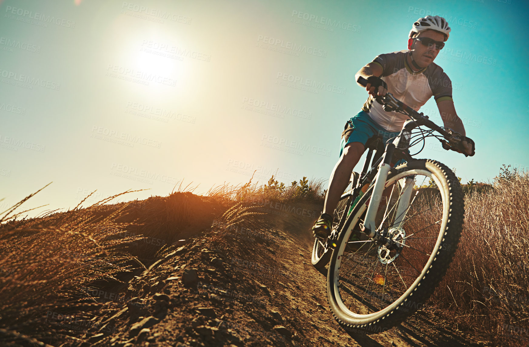 Buy stock photo Cropped shot of a man out cycling in the countryside