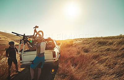 Buy stock photo Shot of a pair of adventurous mountain bikers getting ready to explore a new trail together