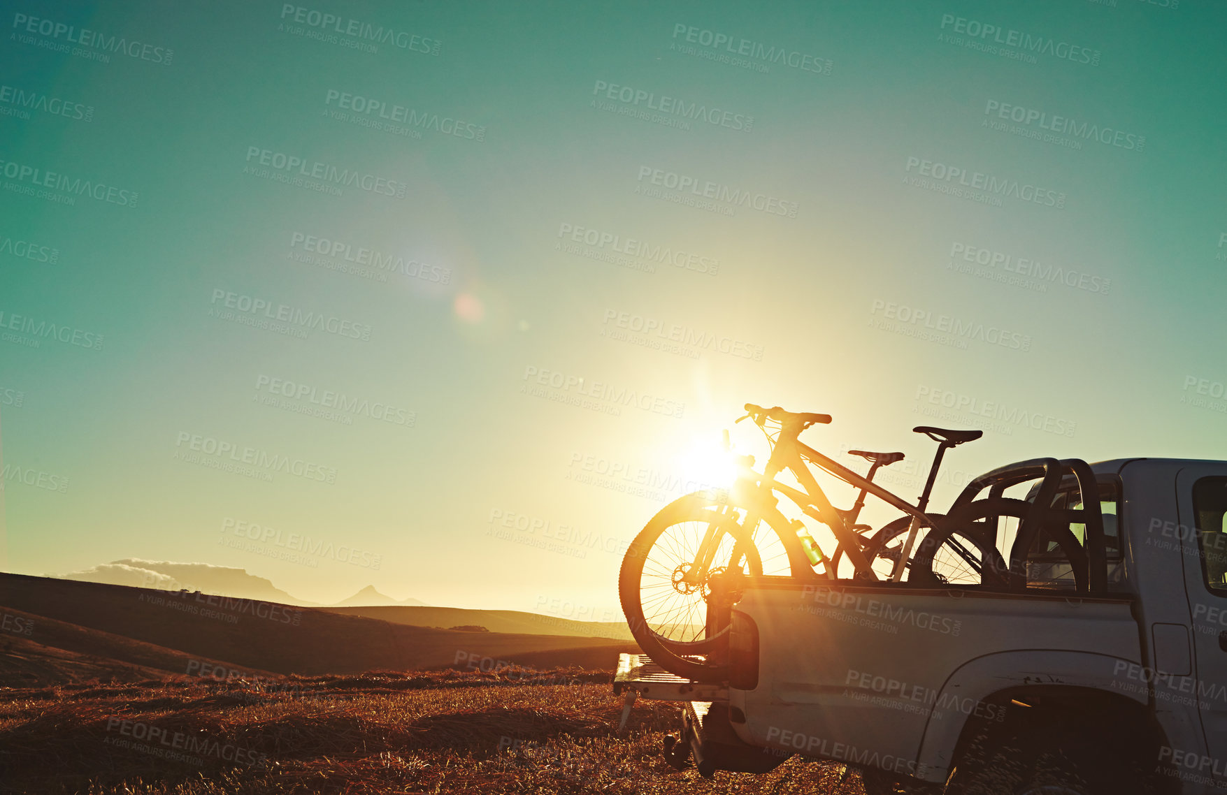 Buy stock photo Sports, lens flare and bicycle on car in nature for training, workout and exercise in countryside. Fitness, cycling and mountain bike in truck for outdoor adventure, travel journey and transportation