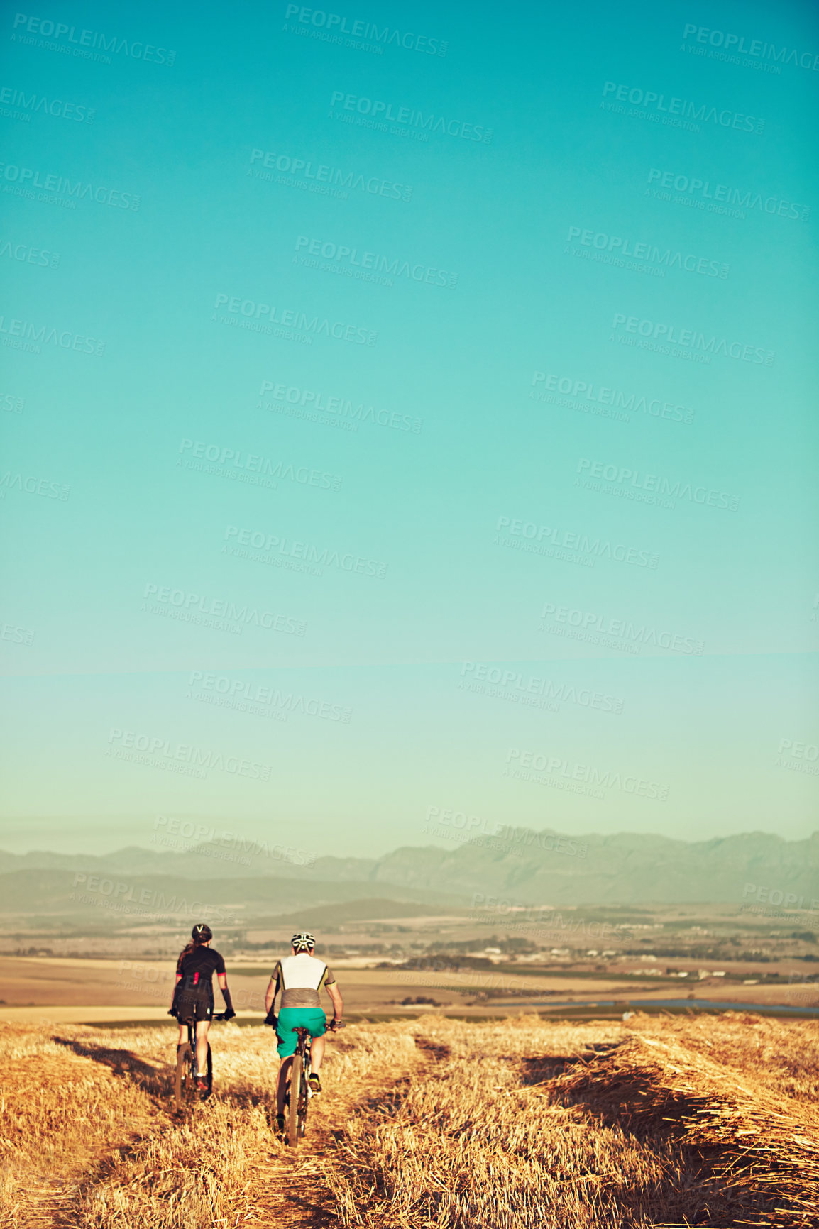 Buy stock photo Shot of two cyclists out cycling in the countryside