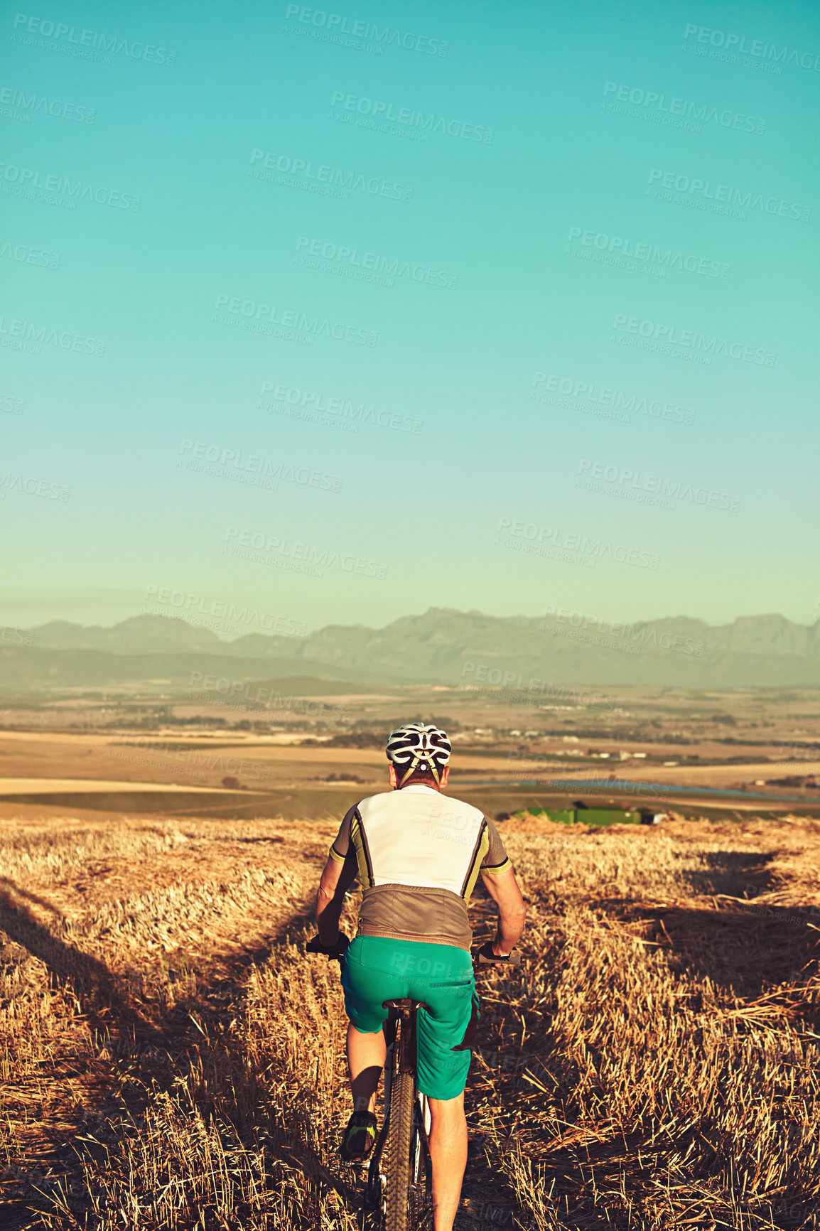 Buy stock photo Cropped shot of a man out cycling in the countryside