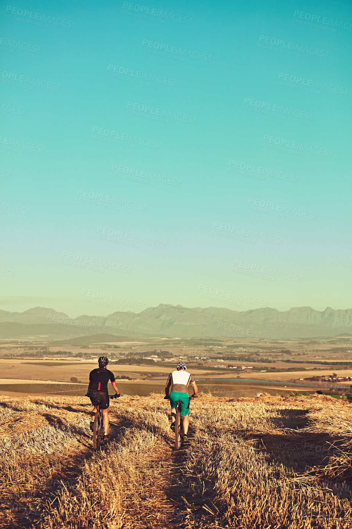 Buy stock photo Shot of two cyclists out cycling in the countryside