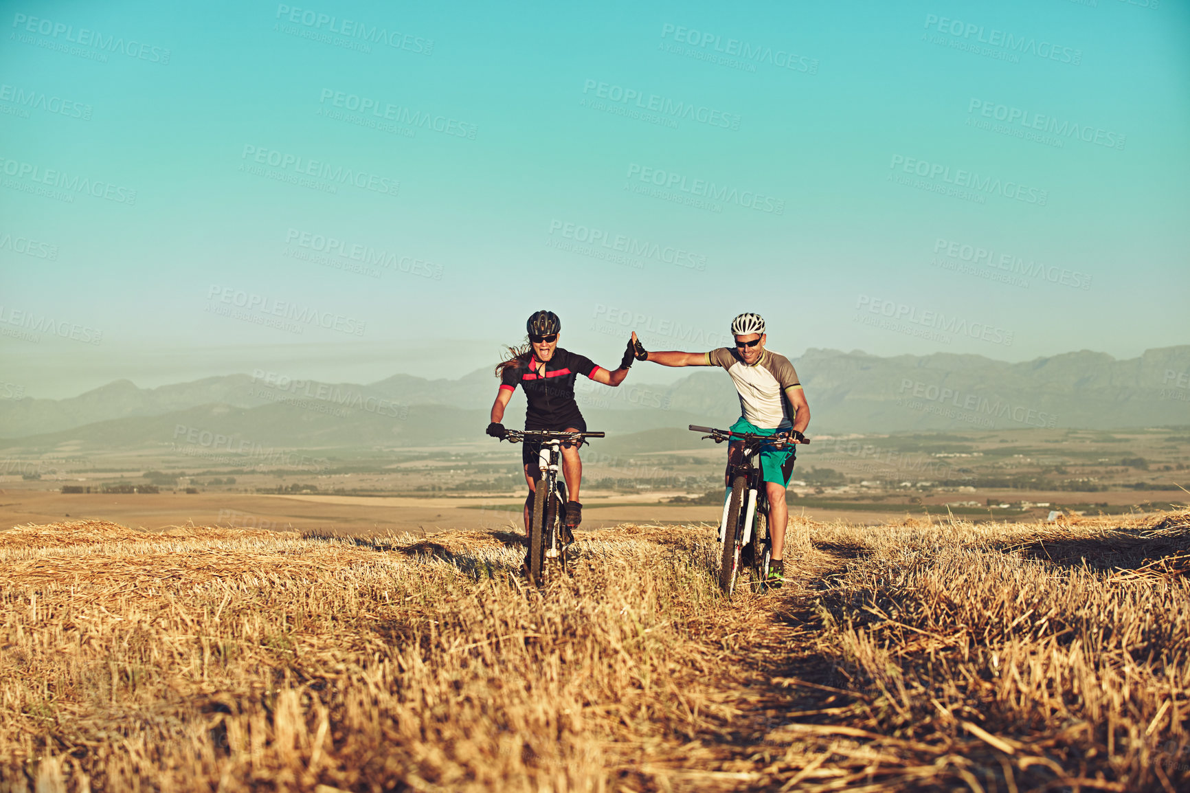 Buy stock photo Shot of two cyclists out cycling in the countryside