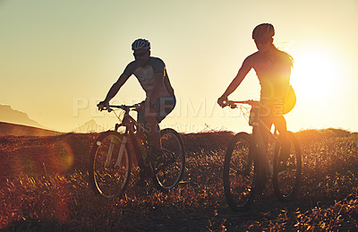 Buy stock photo Sunset, people and team in nature with bicycle, helmet and exercise on adventure trail together. Cycling race, fitness and friends with mountain bike in evening for outdoor workout, energy and mockup