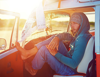 Buy stock photo Shot of a young man out roadtripping in his mini van