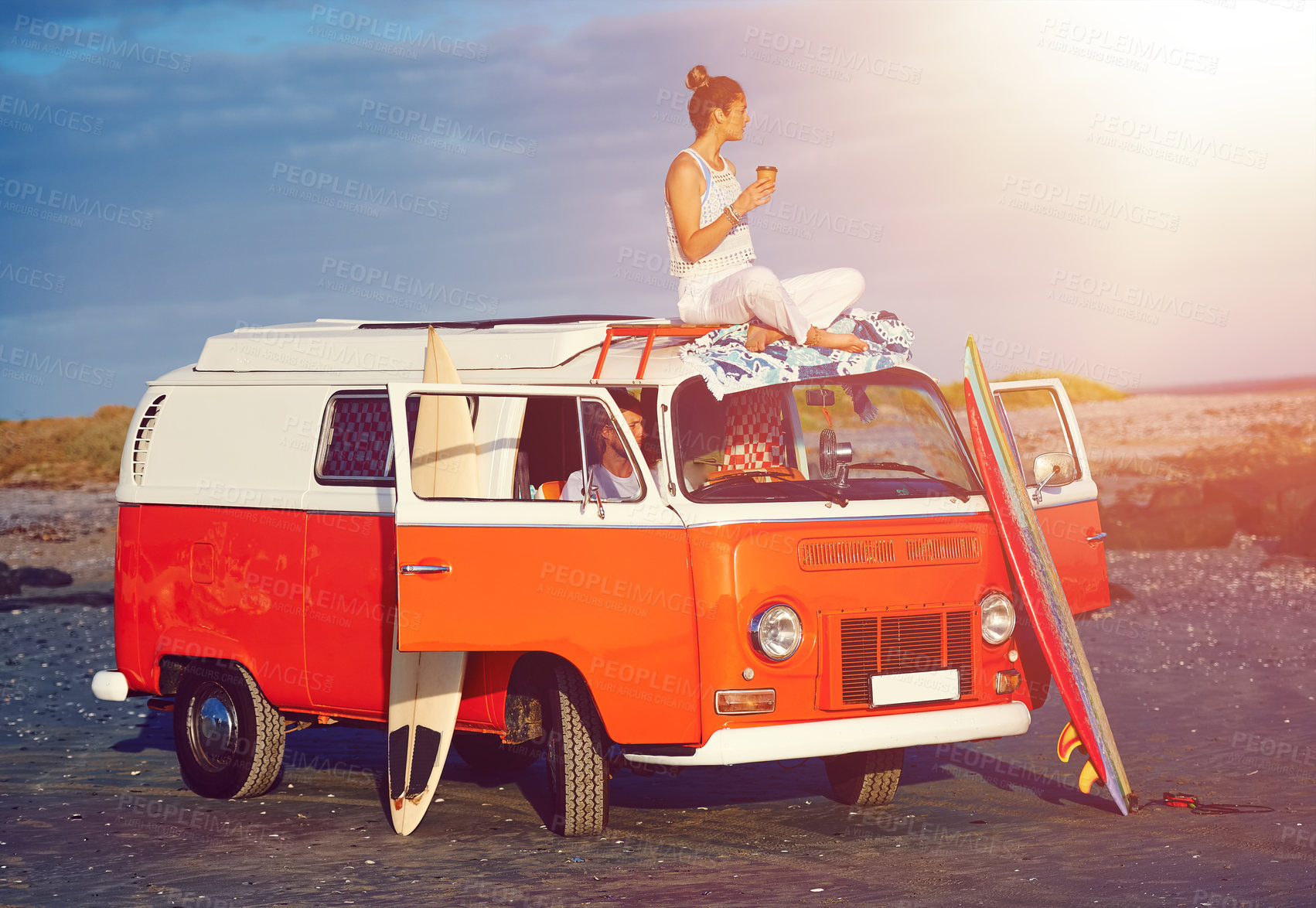 Buy stock photo Shot of an adventurous couple out roadtripping in their mini van