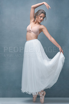 Buy stock photo Shot of a beautiful young woman posing in studio while wearing a bra and ballet skirt