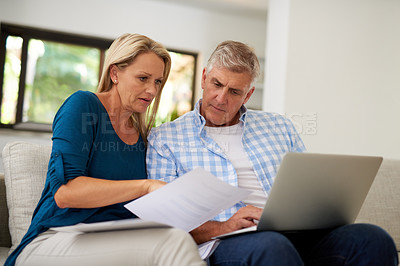 Buy stock photo Cropped shot of a mature couple going through their paperwork together at home