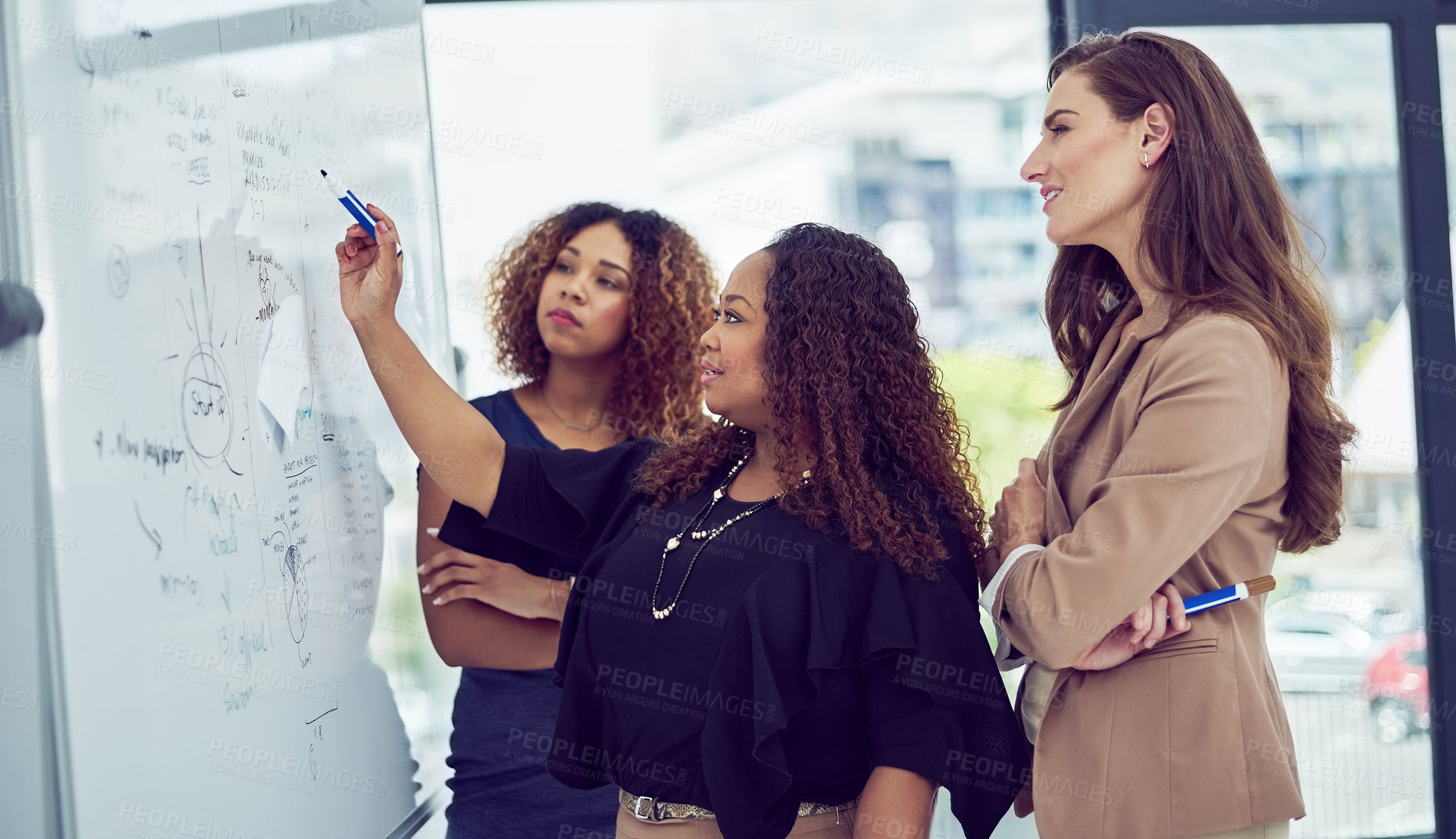 Buy stock photo Cropped shot of a group of businesswomen working on a whiteboard in the boardroom