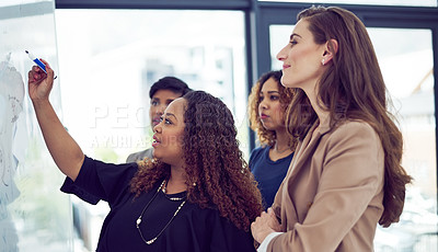 Buy stock photo Cropped shot of a group of businesswomen working on a whiteboard in the boardroom