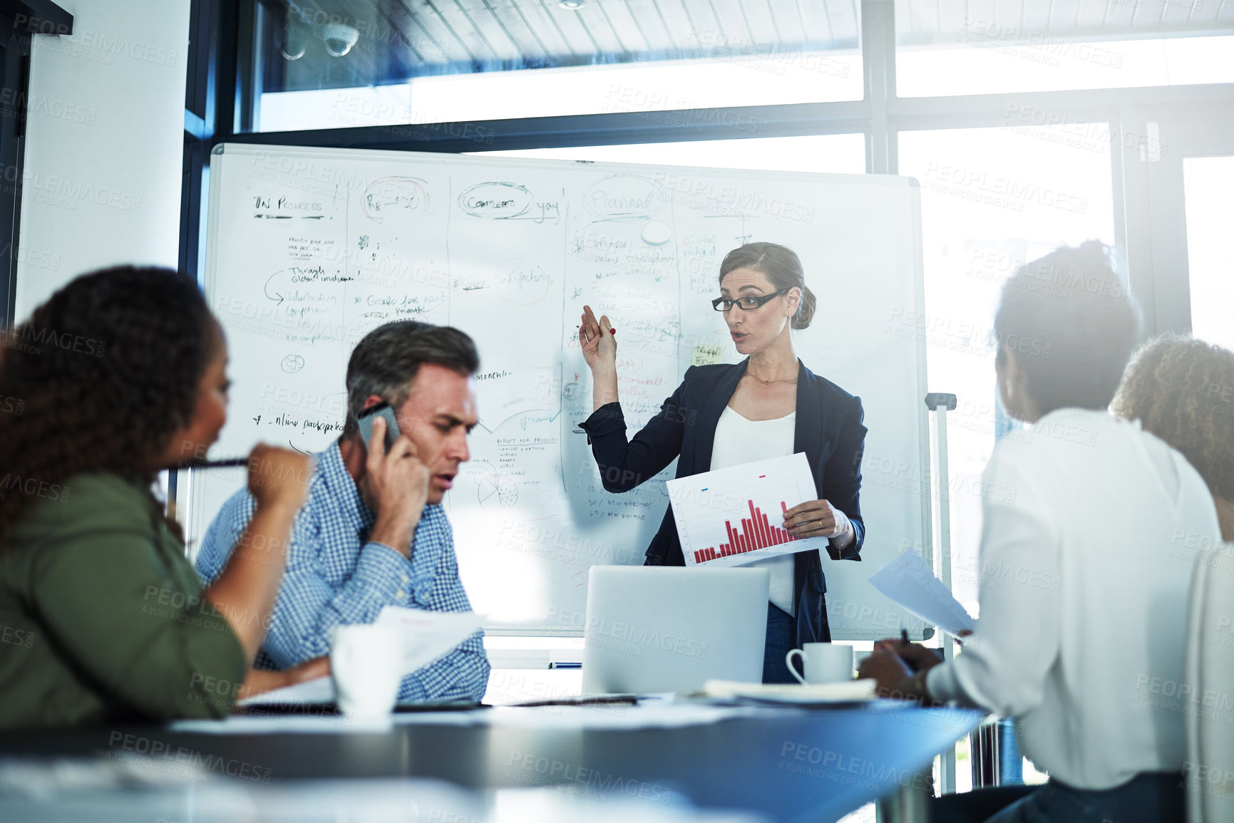 Buy stock photo Shot of a group of focussed businesspeople attending a colleague's presentation in the boardroom