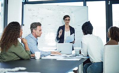 Buy stock photo Shot of a group of focussed businesspeople attending a colleague's presentation in the boardroom