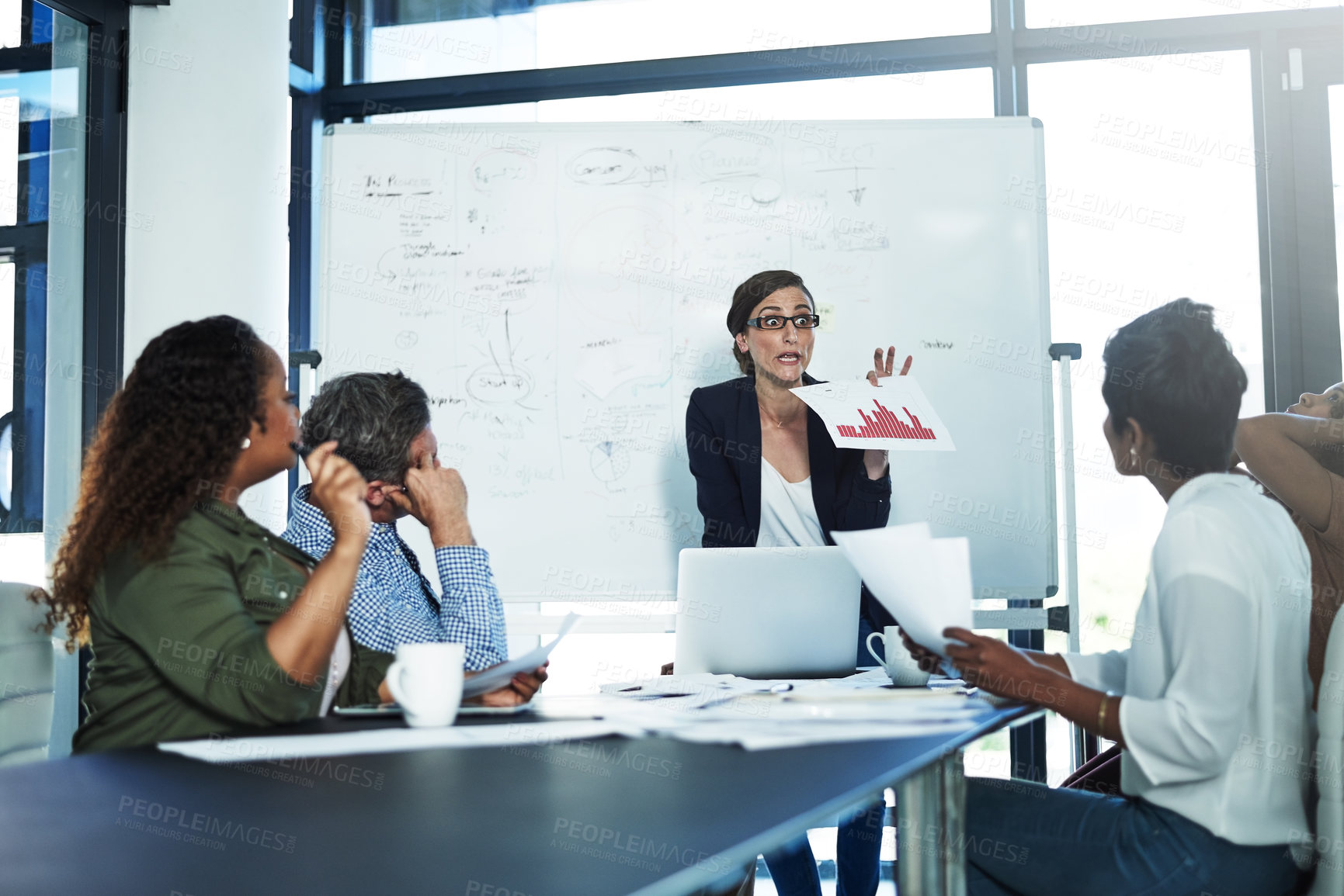 Buy stock photo Shot of a stressed businesswoman losing her temper during a meeting with her colleagues in the boardroom