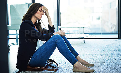 Buy stock photo Shot of a stressed businesswoman sitting on the floor outside the boardroom