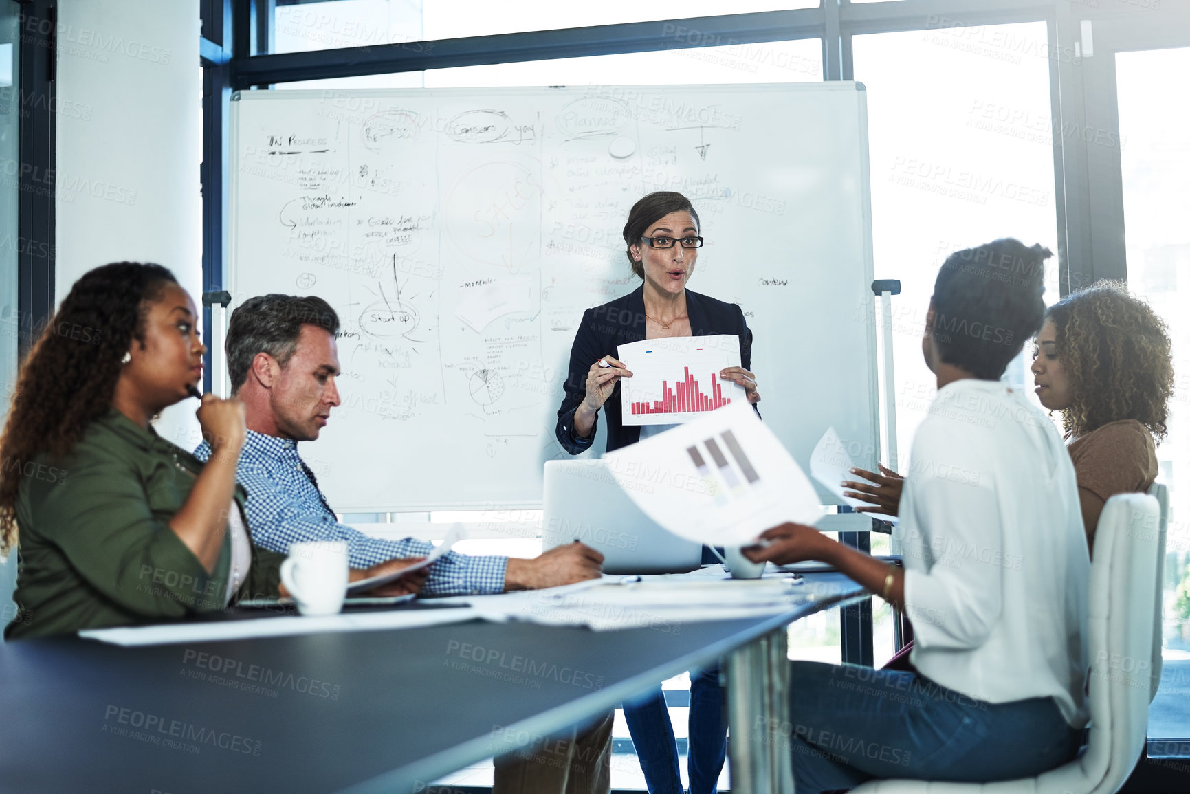 Buy stock photo Shot of a stressed businesswoman losing her temper during a meeting with her colleagues in the boardroom